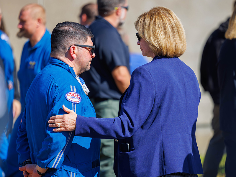 Dr. LouAnn Woodward, vice chancellor for health affairs, offers condolences to flight nurse Paul Boackle.